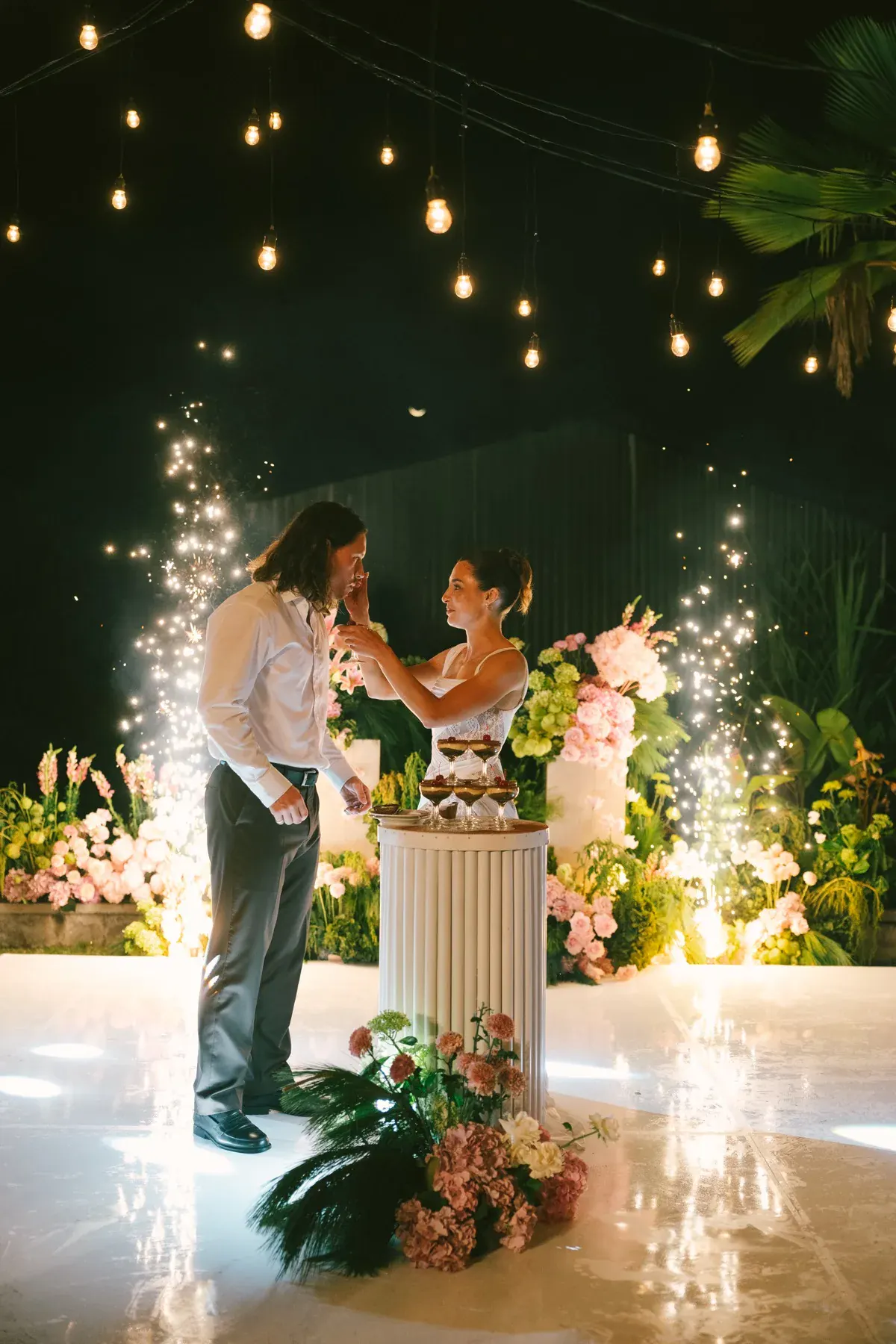 Cake and sparklers and string lights — the night is just beginning