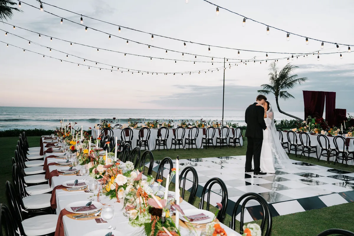 First dance on a checkered floor at sunset by the sea